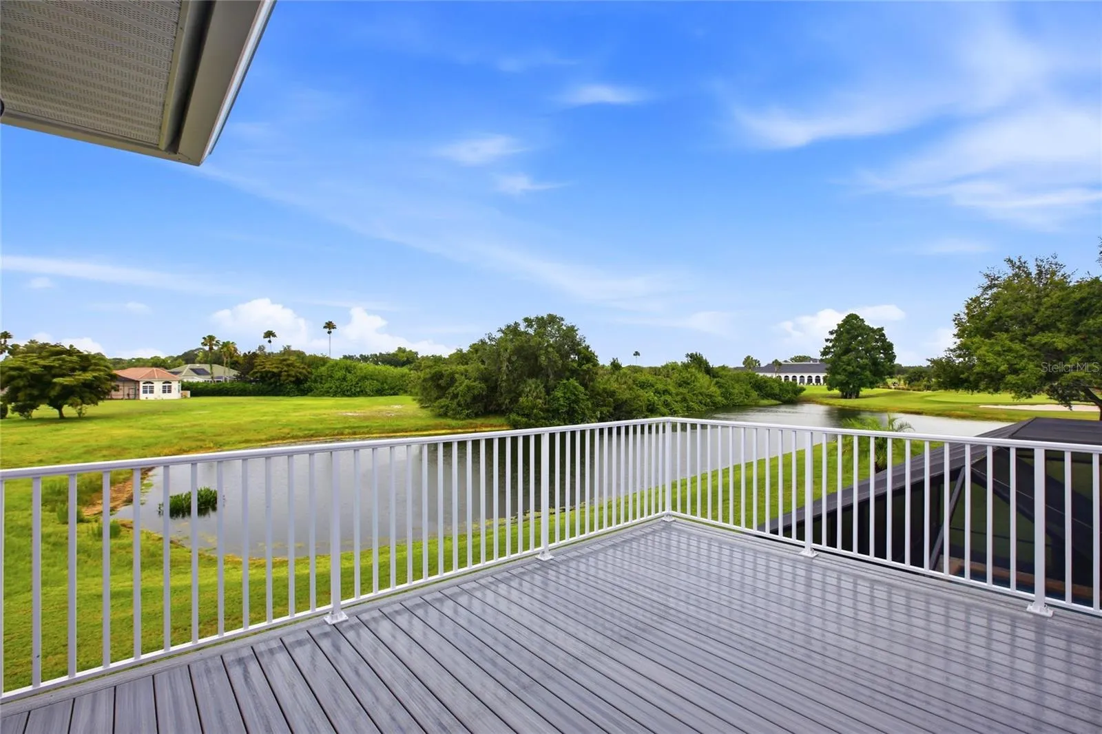 The upstairs balcony overlooks the lake and 18th Hole of Misty Creek.