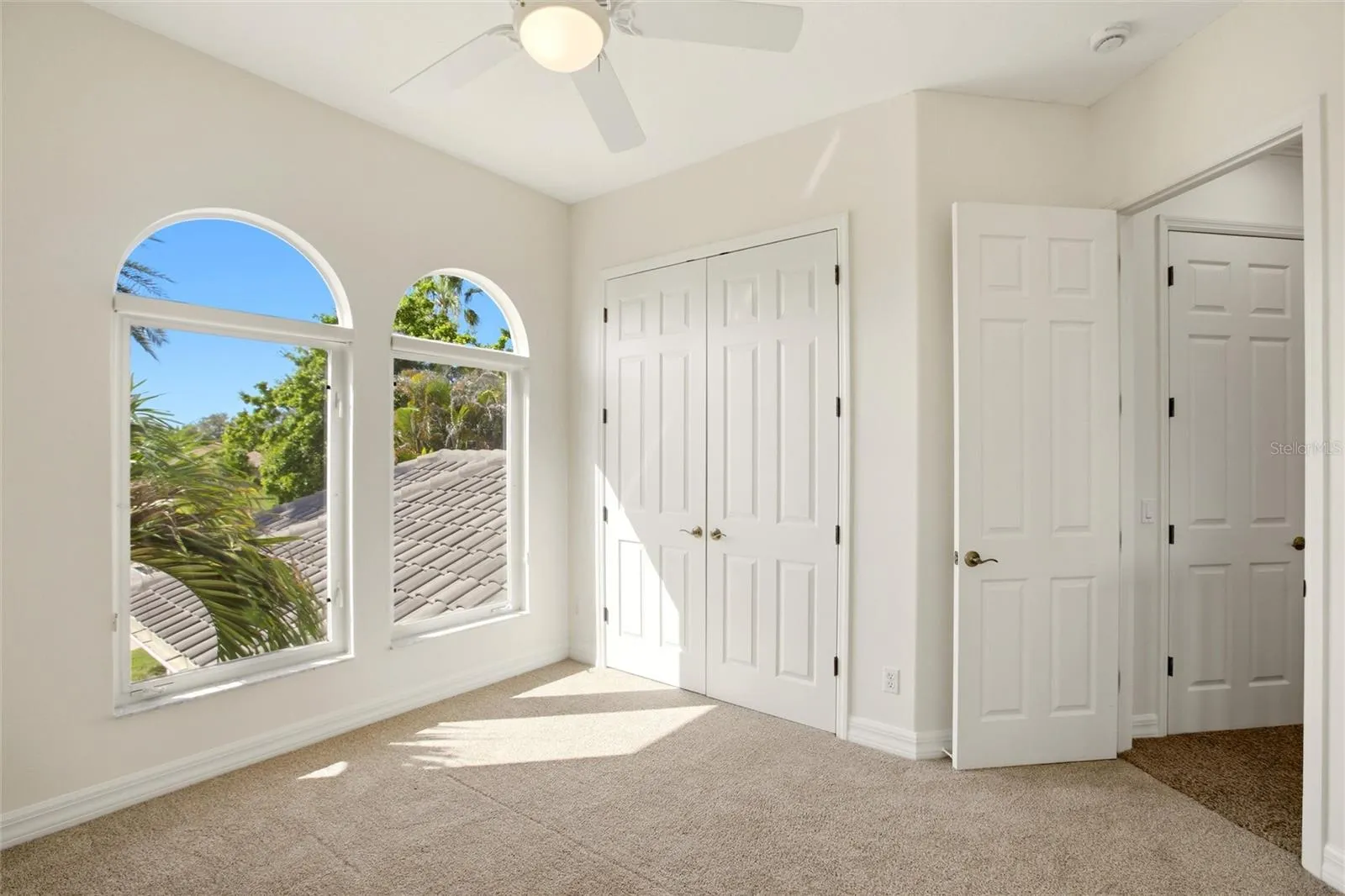 The bedroom features a built-in closet and convenient access to a nearby hall bathroom.