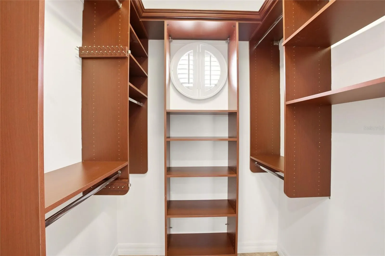 The primary bathroom features a soaking tub, split vanities with dedicated makeup counter space, a spacious walk-in shower with dual shower heads, a private water closet, and dual walk-in closets with custom organization.
