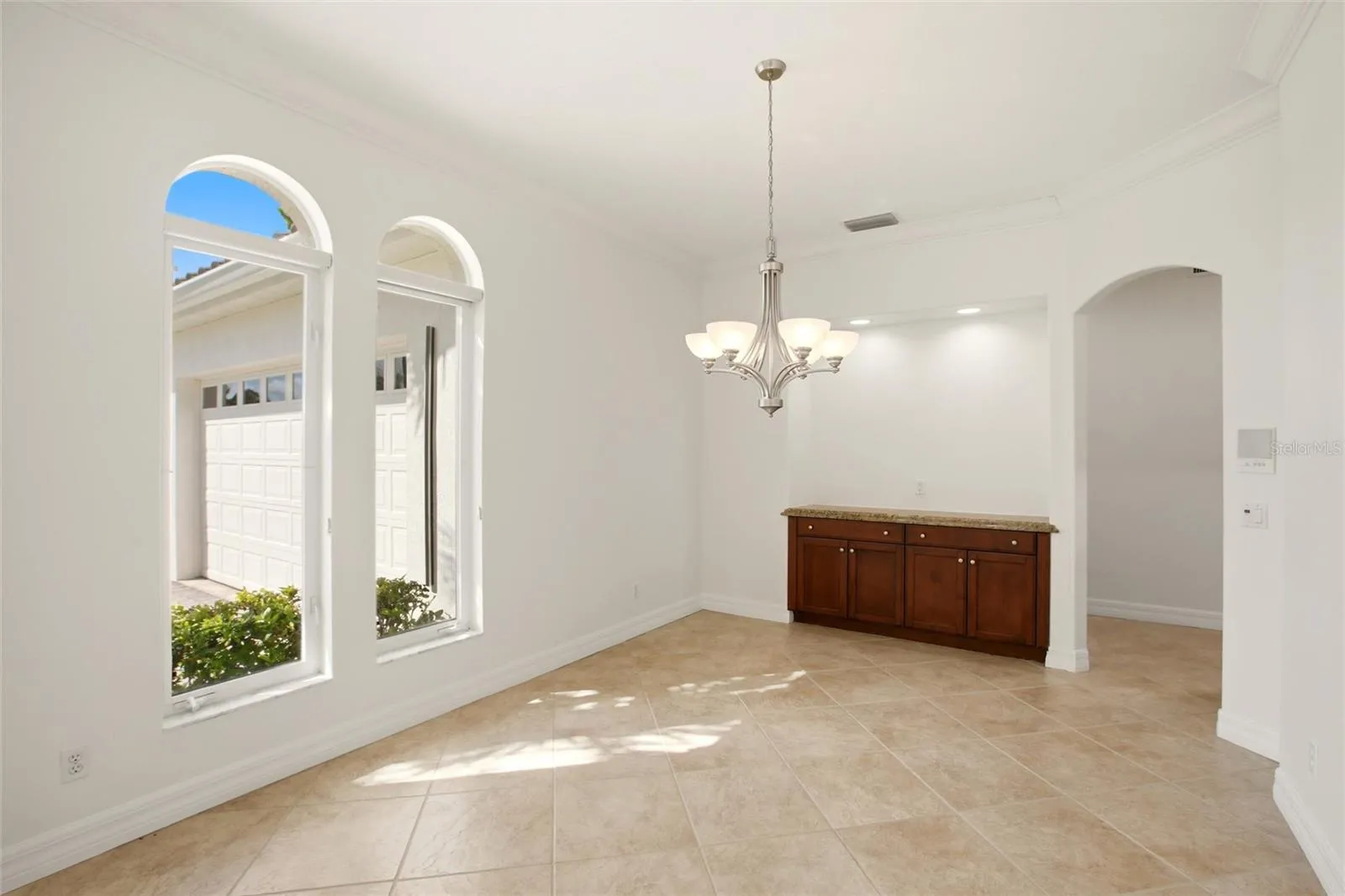 A separate dining room is conveniently located just off the kitchen and features built-in cabinetry, offering both elegance and functional storage.