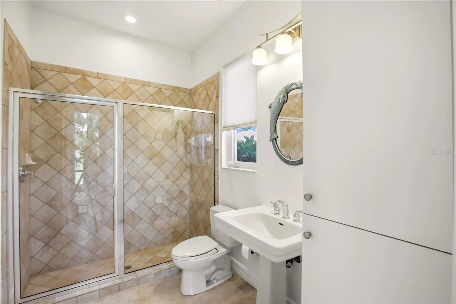 The pool bath is conveniently located by the lanai access and also serves as a versatile first-floor guest bathroom.