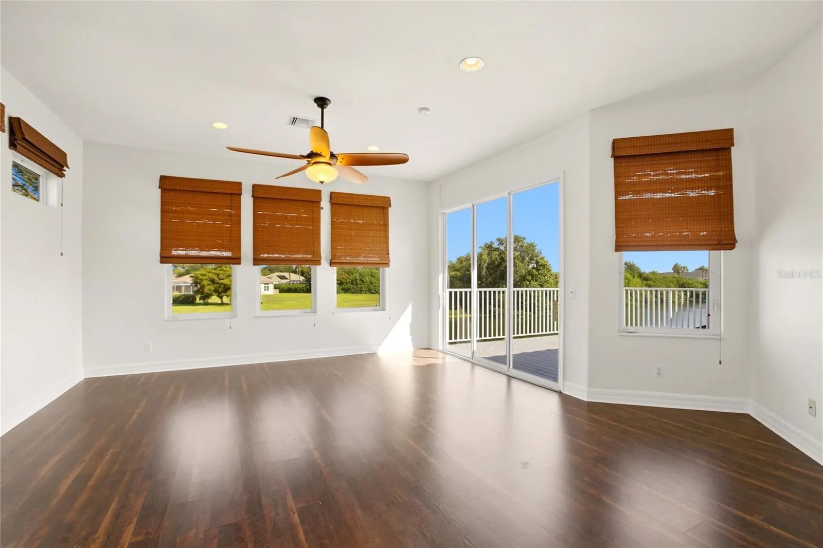 The spacious bonus room offers exceptional versatility, serving as an ideal playroom, guest quarters, media room, or workout space. It is well-appointed with a wet bar, refrigerator, washer and dryer, and a large storage closet, and opens through sliding glass doors to a private second-floor balcony overlooking the lake and golf course. A dumbwaiter provides convenient access from the kitchen below.