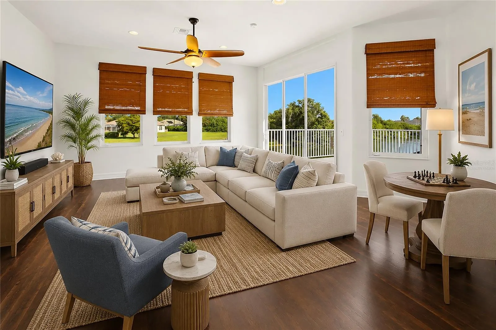 This photo is virtually staged. The spacious bonus room offers exceptional versatility, serving as an ideal playroom, guest quarters, media room, or workout space. It is well-appointed with a wet bar, refrigerator, washer and dryer, and a large storage closet, and opens through sliding glass doors to a private second-floor balcony overlooking the lake and golf course. A dumbwaiter provides convenient access from the kitchen below.