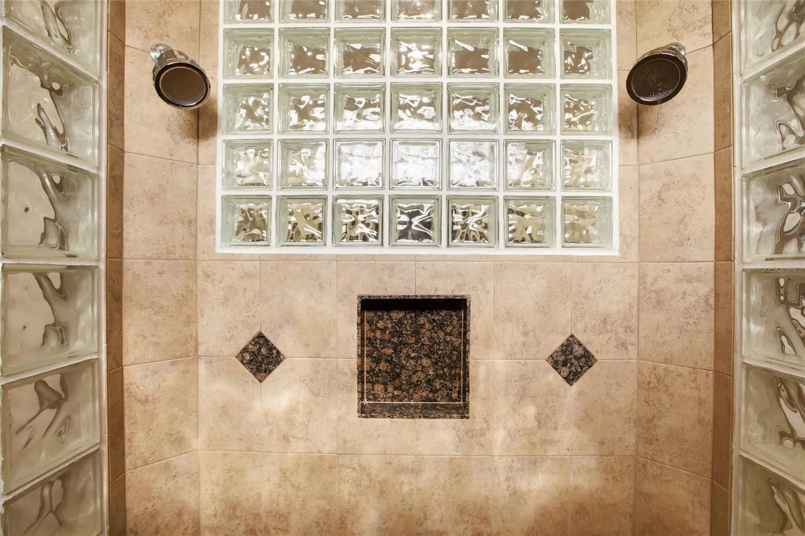 The primary bathroom features a soaking tub, split vanities with dedicated makeup counter space, a spacious walk-in shower with dual shower heads, a private water closet, and dual walk-in closets with custom organization.