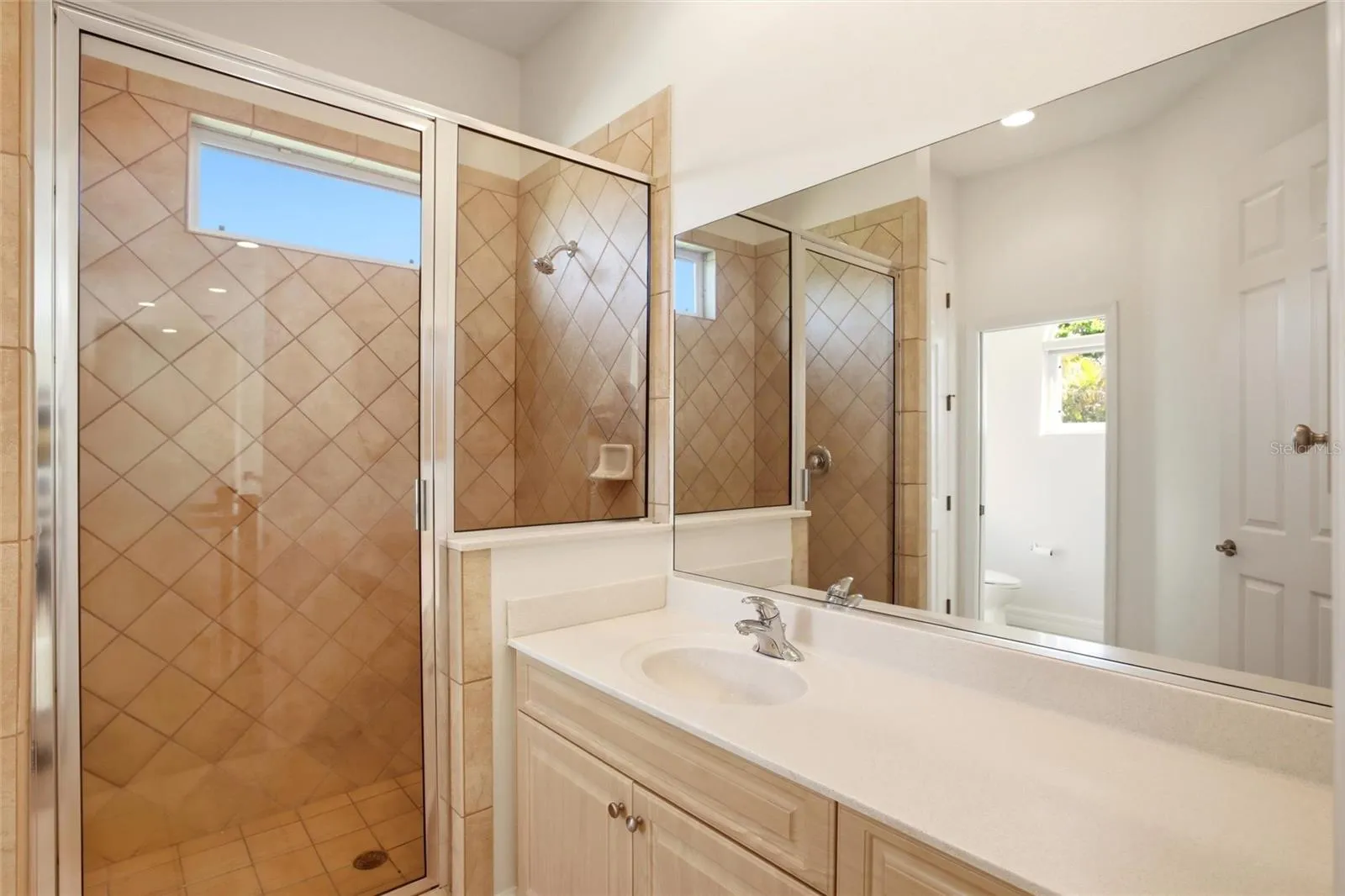 The hall bathroom features a spacious walk-in shower, a sink vanity, a private water closet, and a linen closet, and is conveniently accessible from both the bonus room and the upstairs bedrooms.