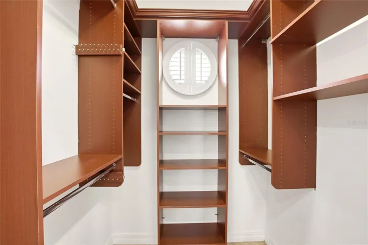 The primary bathroom features a soaking tub, split vanities with dedicated makeup counter space, a spacious walk-in shower with dual shower heads, a private water closet, and dual walk-in closets with custom organization.
