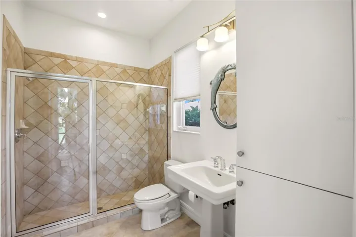 The pool bath is conveniently located by the lanai access and also serves as a versatile first-floor guest bathroom.
