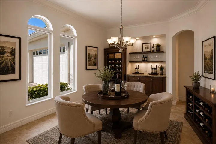 A separate dining room is conveniently located just off the kitchen and features built-in cabinetry, offering both elegance and functional storage. Shown in this photo as a wine room or lounge. The entertaining options are endless.