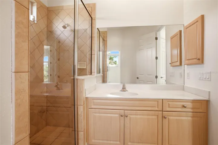The hall bathroom features a spacious walk-in shower, a sink vanity, a private water closet, and a linen closet, and is conveniently accessible from both the bonus room and the upstairs bedrooms.