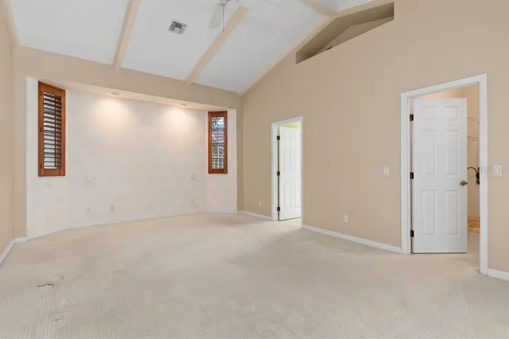 Primary bedtoom with vaulted ceiling