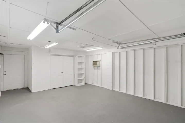 Garage towards storage room (right) and fenced backyard (left).