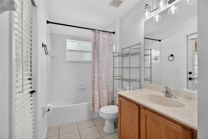2nd bathroom with tub with shower