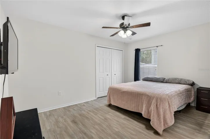 Second Bedroom with ceiling fan and built-in closet