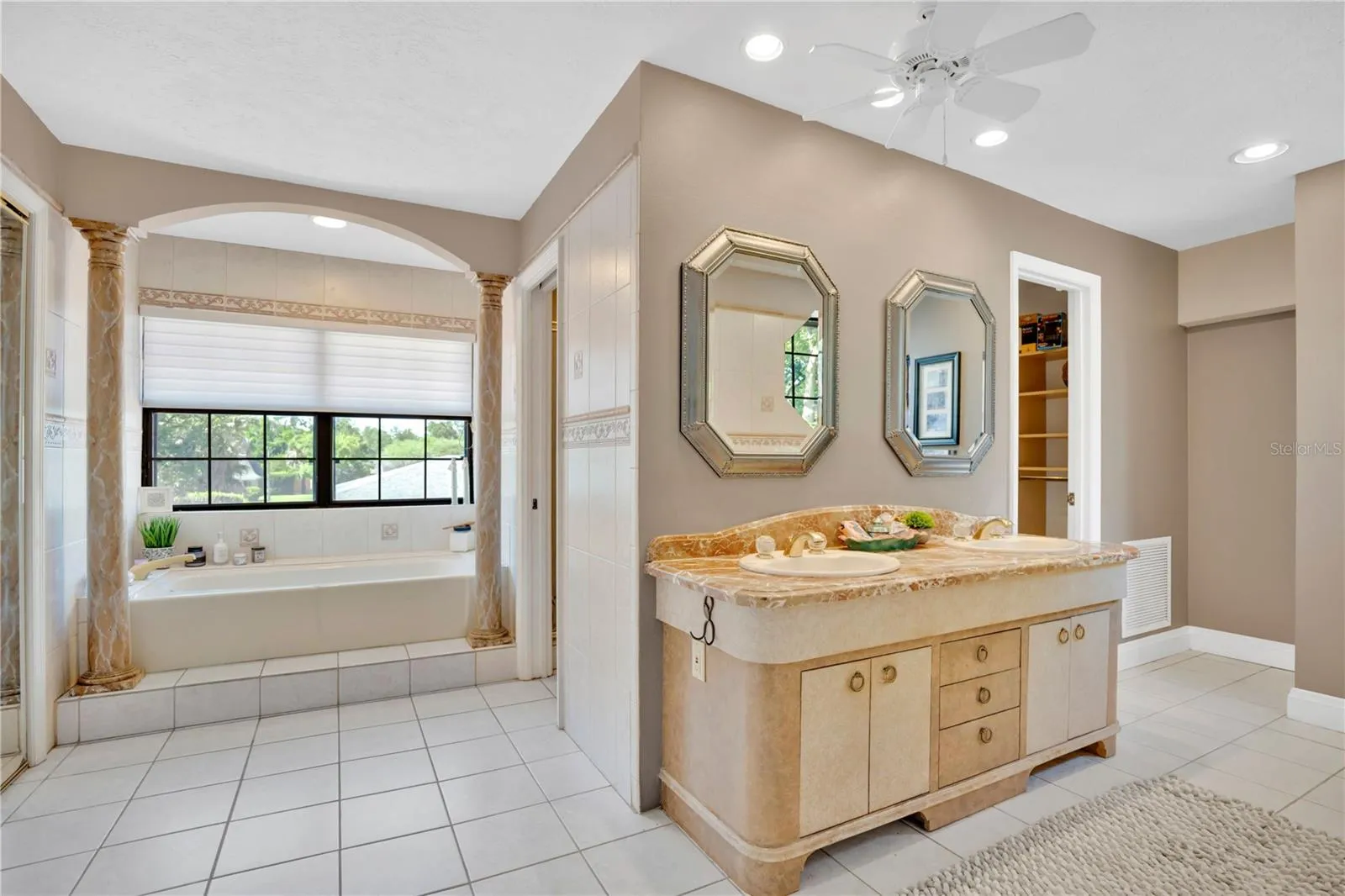The primary bathroom offers dual walk-in closets, a soaking tub, and a separate shower.