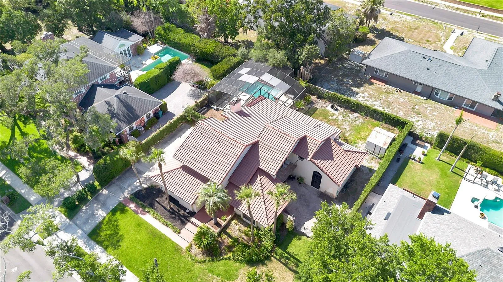 The backyard is fully enclosed by a block wall and secured with wrought iron gates.