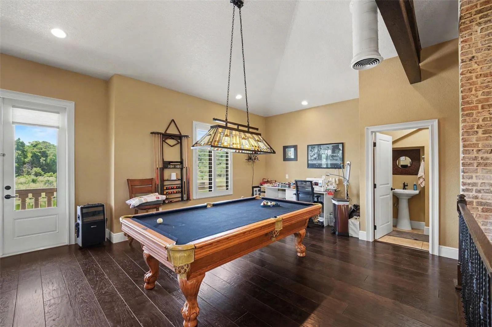 Upstairs loft game room with pool table which conveys