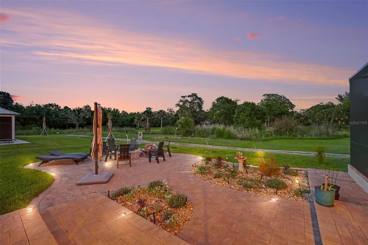 Side yard with fire pit and paved area