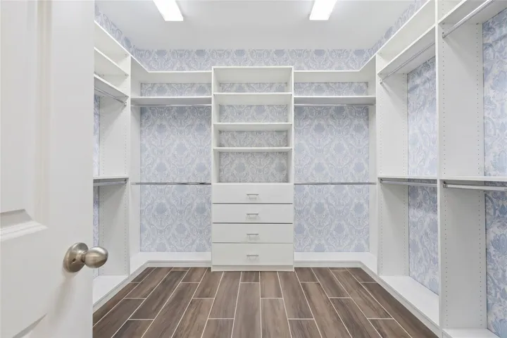 Walk-in California closet for the Primary Bedroom (staged as empty)