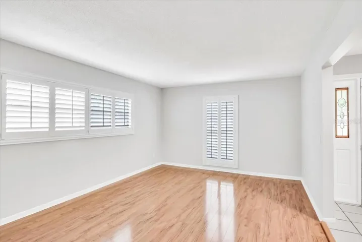 Living area #2 with upgraded hardwood floors and plantation style shutters.