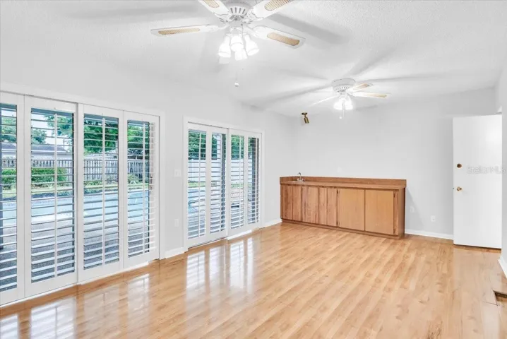 Living area #3 with beautiful hardwood flooring and wet bar.