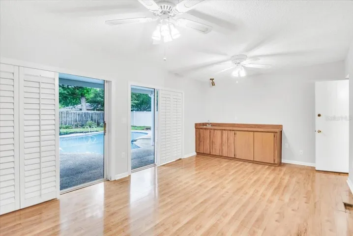 Living area #3 to pool deck with plantation shuttered sliding doors.