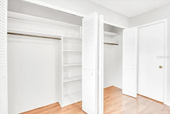 Bedroom #3 features large closet with hardwood flooring.