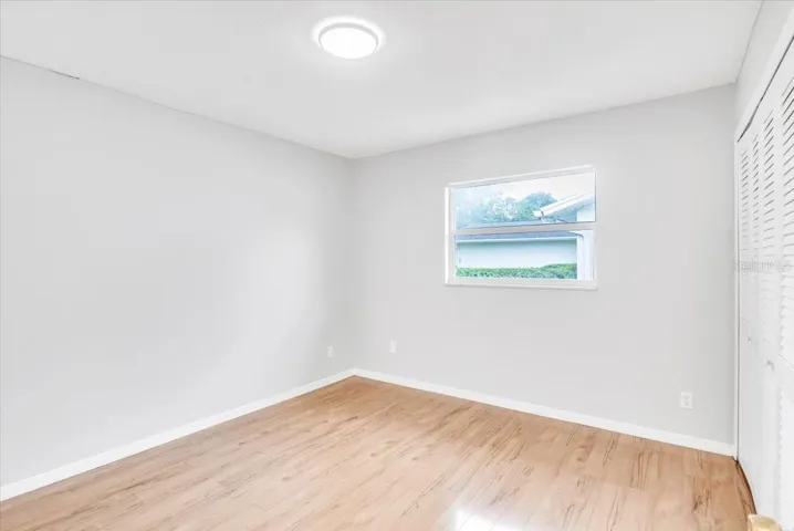 Bedroom #2 with hardwood flooring.