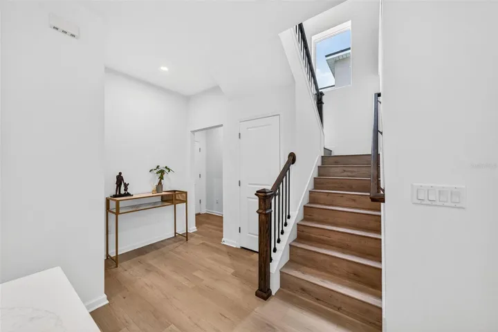 Stair landing, half bathroom and mud room