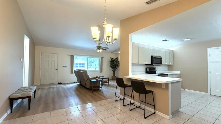 Dining area and galley-style kitchen with counter seating