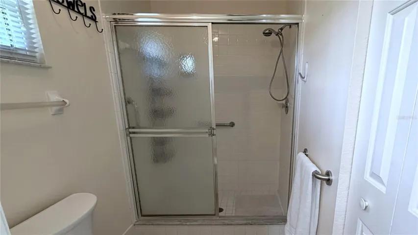 Primary ensuite bathroom with enclosed shower