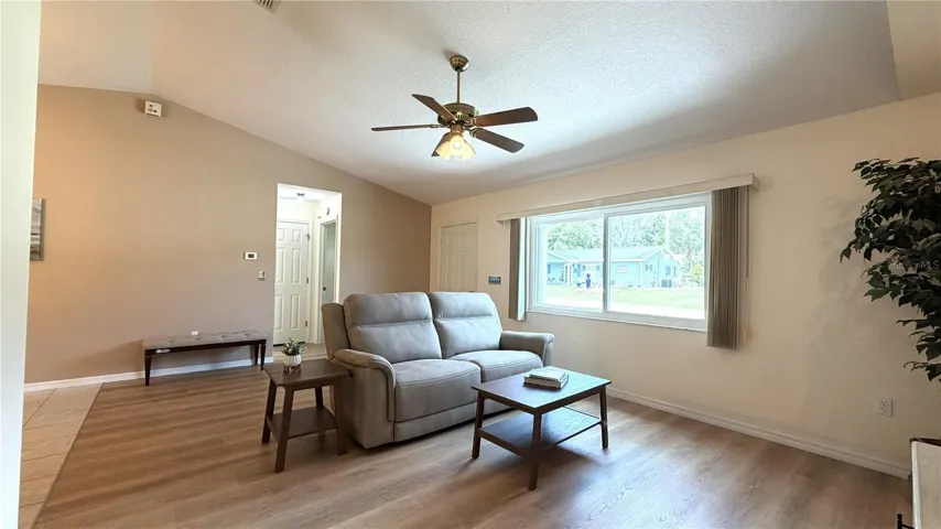 Living room with luxury vinyl flooring and front window