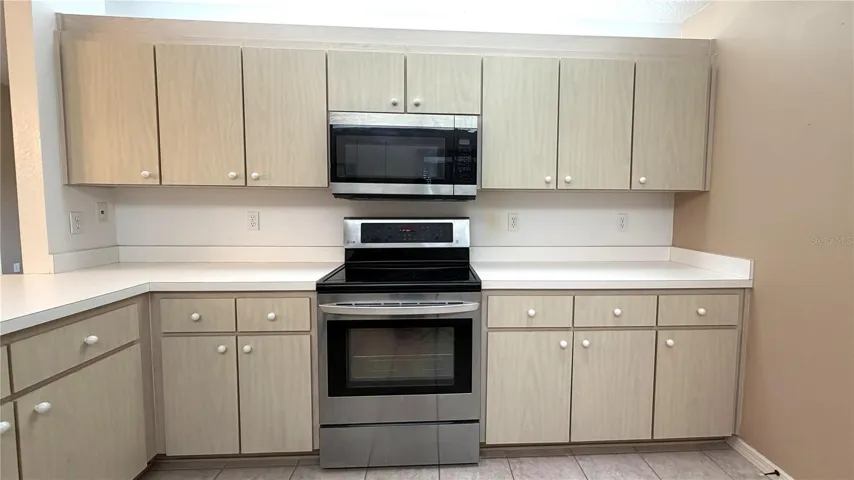Galley-style kitchen with generous cabinet and counter space
