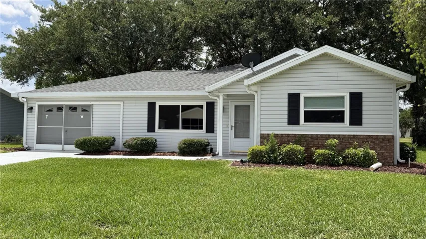 Front exterior with mature landscaping and covered entry