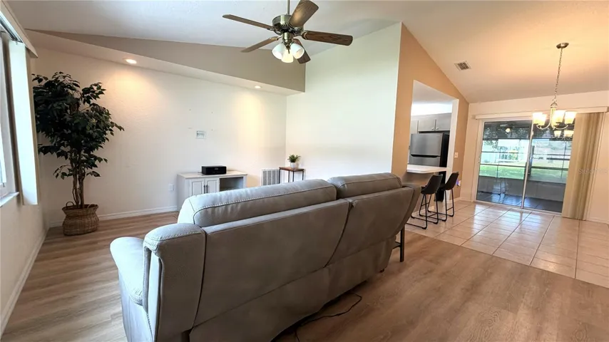Living area with luxury vinyl flooring and open flow to dining space