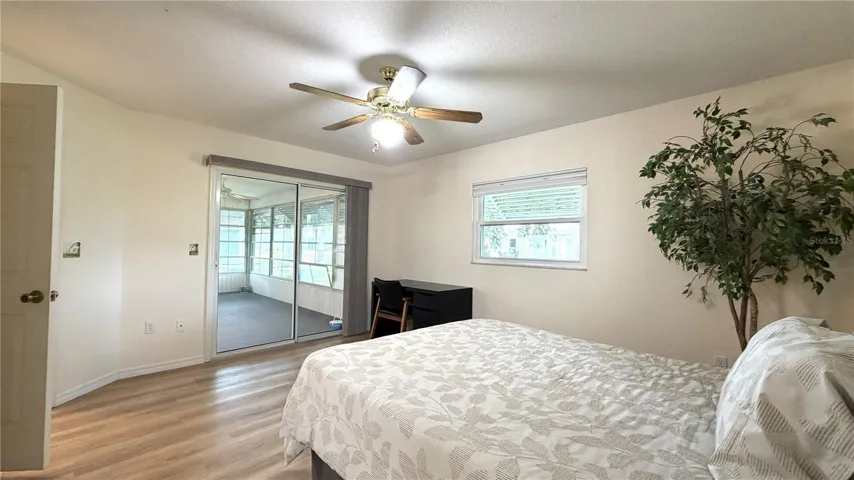 Primary bedroom with sliding door access to enclosed lanai