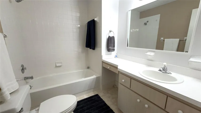 Guest bathroom with tub/shower combination and vanity counter space