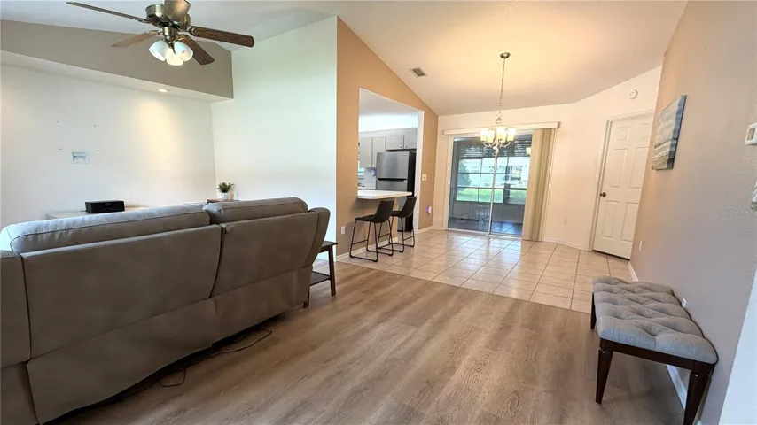 Living and dining areas with no carpet and sliding door access to lanai