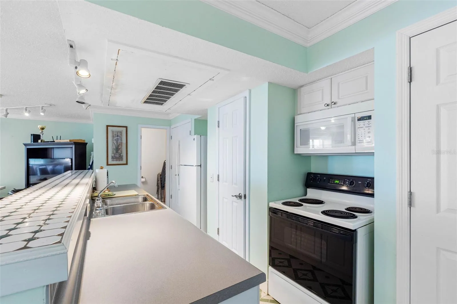 Clubroom is equipped with a stove, microwave and many kitchen equipment items