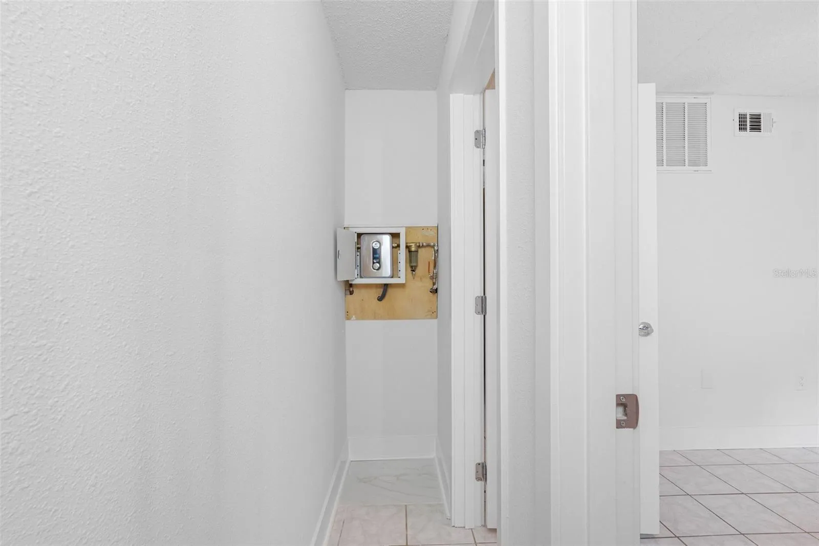 Tankless water heater in closet of bedroom