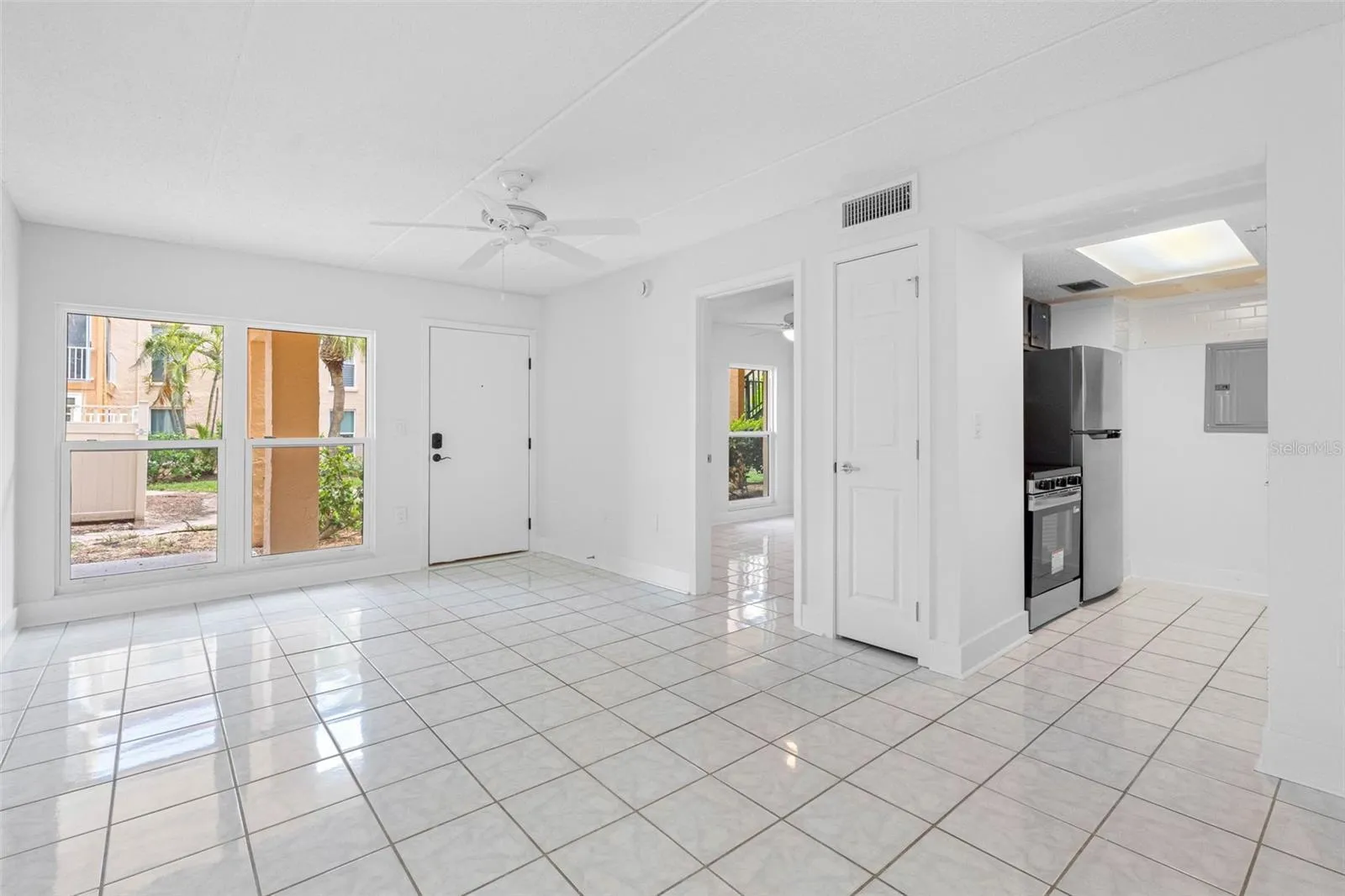 View of living entry to kitchen and bedroom.