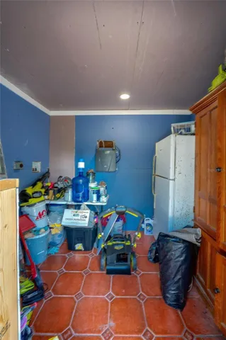 Practical storage room, the space features blue walls and floor tiles.