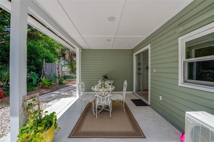Inviting covered patio space complete with sliding glass door access to the home's interior