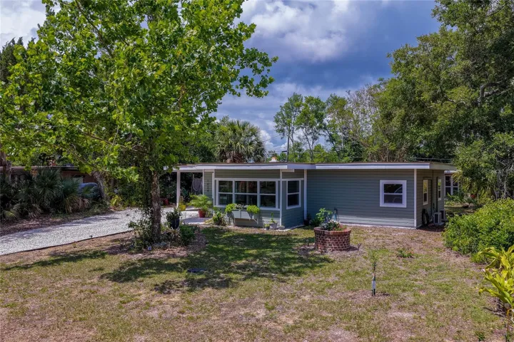 Beautifully updated ranch-style home surrounded by mature trees and natural landscaping, featuring abundant natural light, a spacious yard, and a peaceful private setting with charming curb appeal.