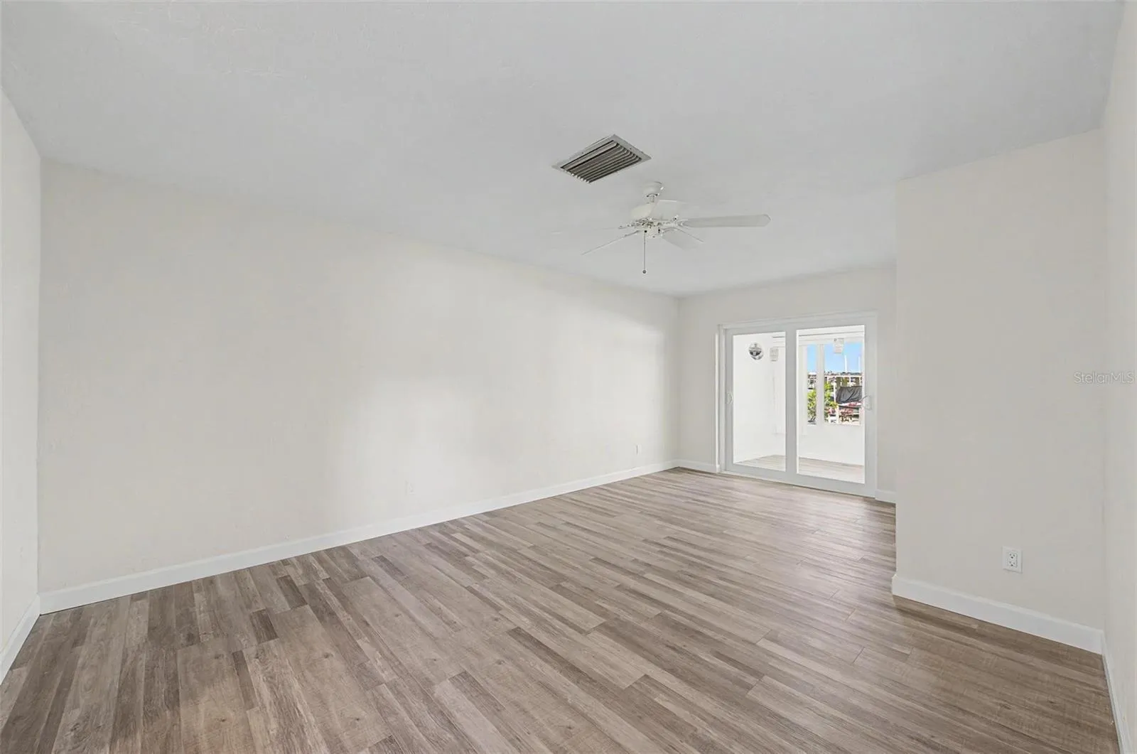 Primary Bedroom with sliding door access to Sunroom