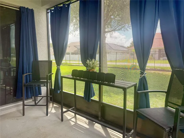Additional view of covered and screened in lanai with view of sliding glass doors leading into the primary bedroom