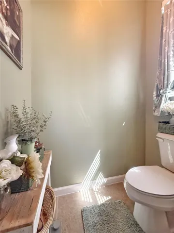 Primary bathroom, separate water closet with ceramic tile floor flooring