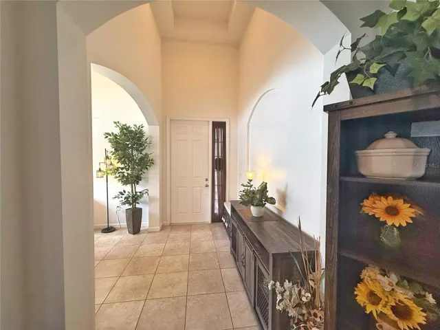 Front Entry with tray ceiling and view of Dining room on left