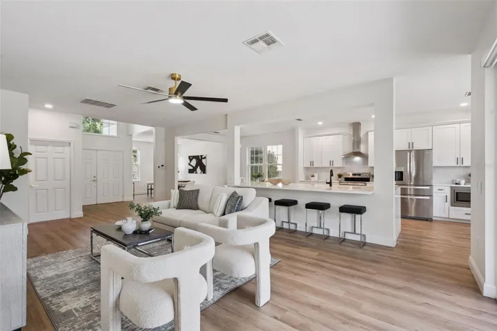 Spacious open-concept layout connecting the living room, dining area, and kitchen for effortless entertaining. The large breakfast bar and modern finishes enhance both style and functionality.