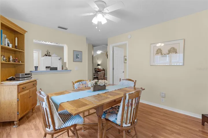 VIEW OF DINING ROOM WITH SERVING WINDOW AND ACCESS TO GUEST BEDROOM