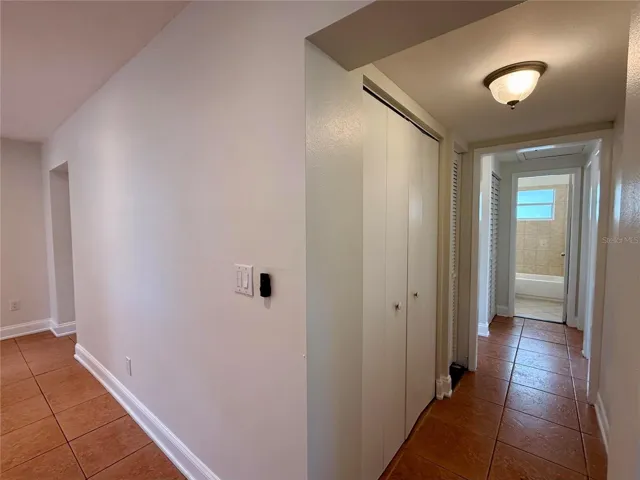 Hallway Off Kitchen with Pantry and Broom Closet